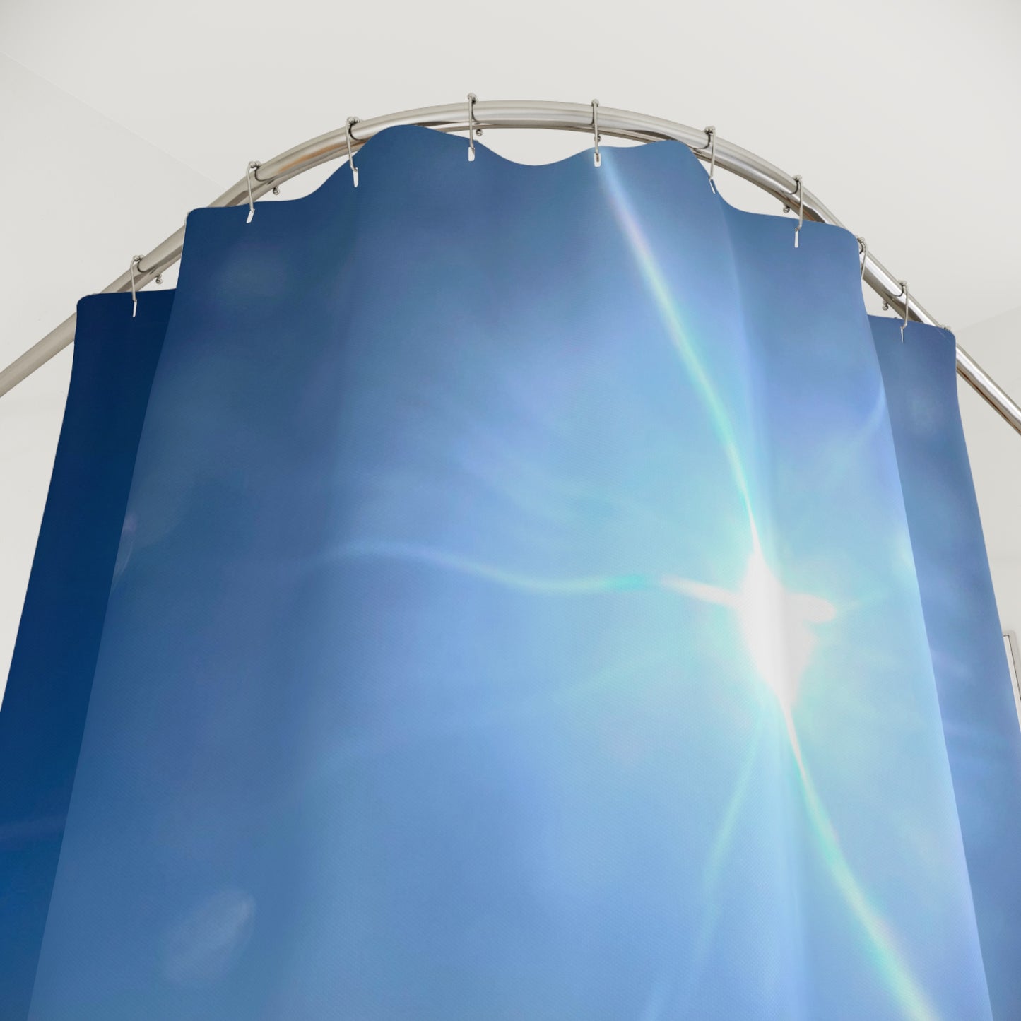 Shower curtain with bright sun and deep blue sky design. Bringing airy, uplifting vibes to your bathroom.