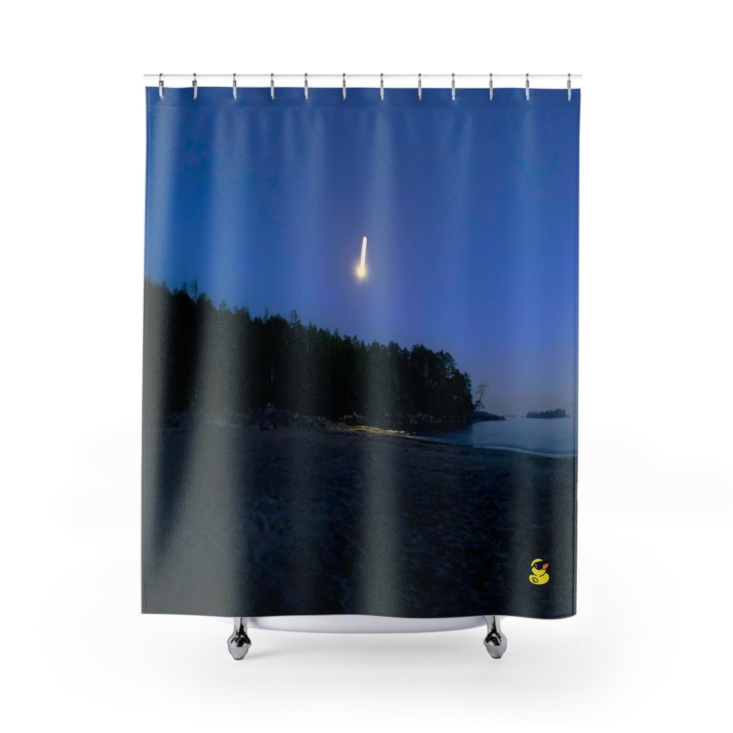 Shower curtain featuring a nighttime beach scene with a glowing shooting star above a silhouetted treeline, under a deep blue sky.