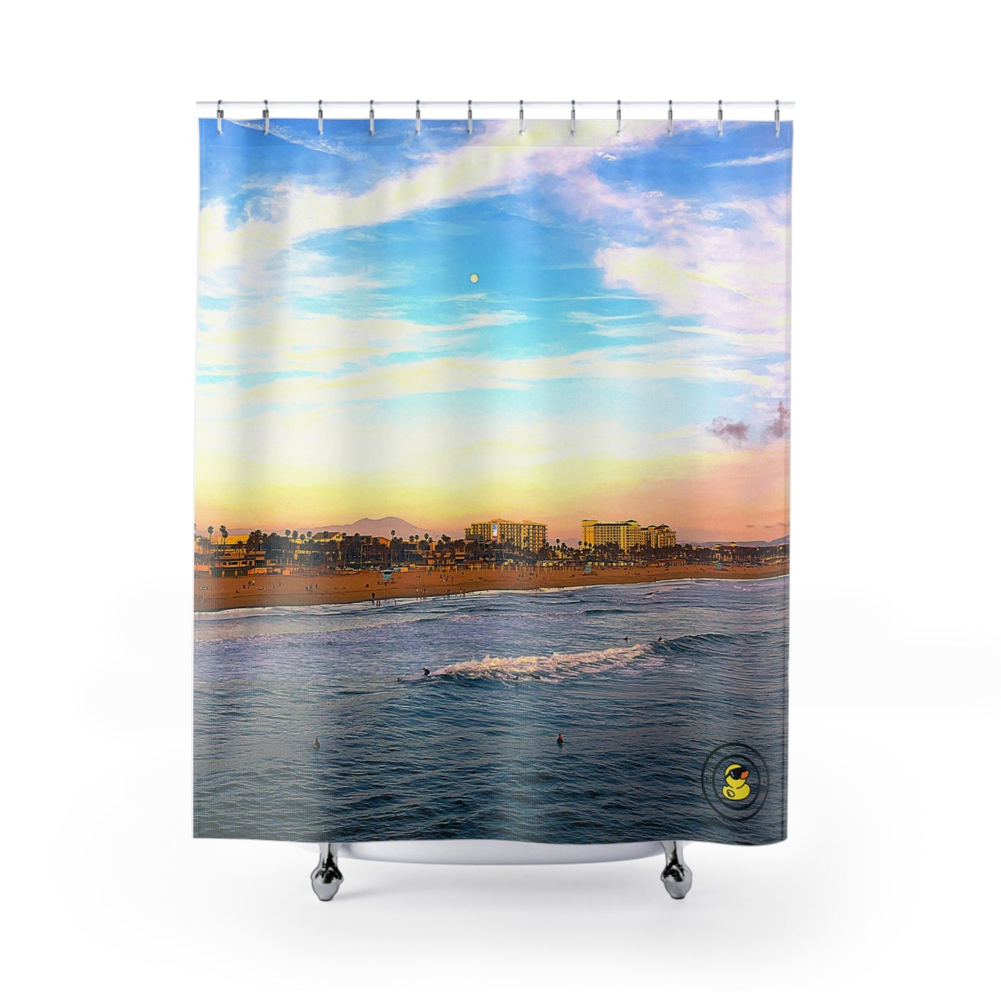 Colorful shower curtain featuring a Malibu beach scene with gentle waves, surfers, and a pastel sunset sky.