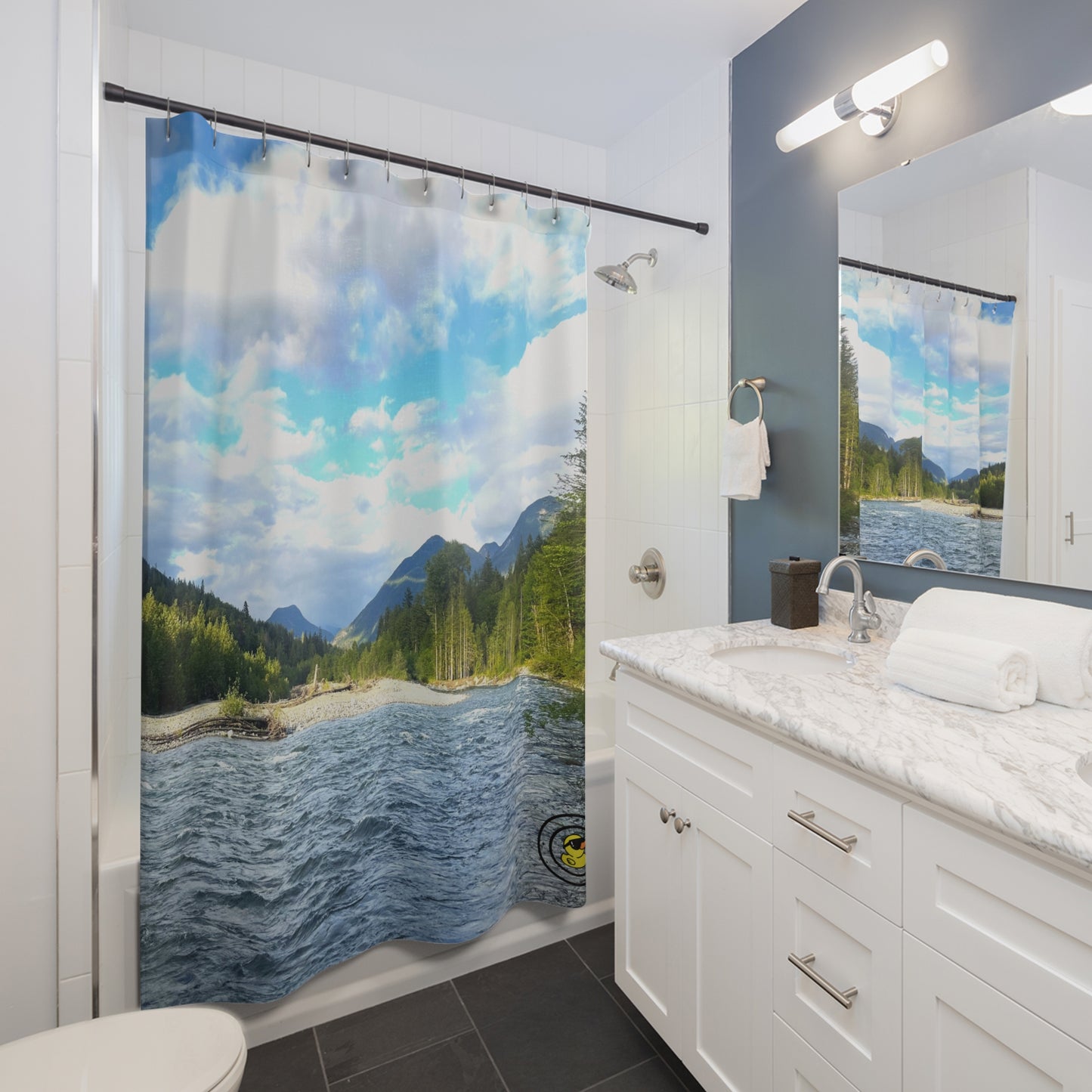 Bathroom easily renovated with nature-themed shower curtain featuring a flowing river, pine trees, and distant mountains.