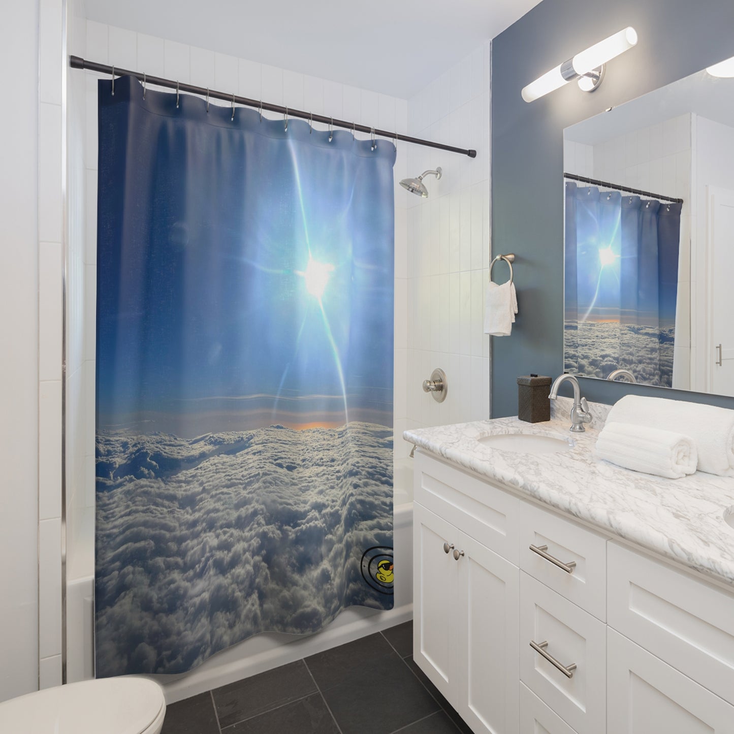 Bathroom with 'Above the Clouds' shower curtain featuring bright sunlight and a stunning aerial view of clouds.