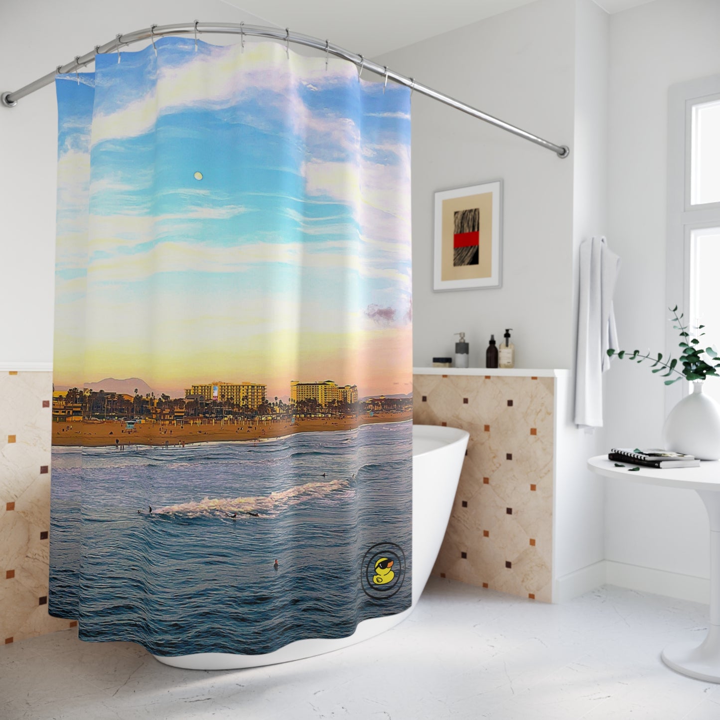 Bathroom with a Malibu themed shower curtain featuring a pastel sky, city skyline, and calm ocean at sunset.