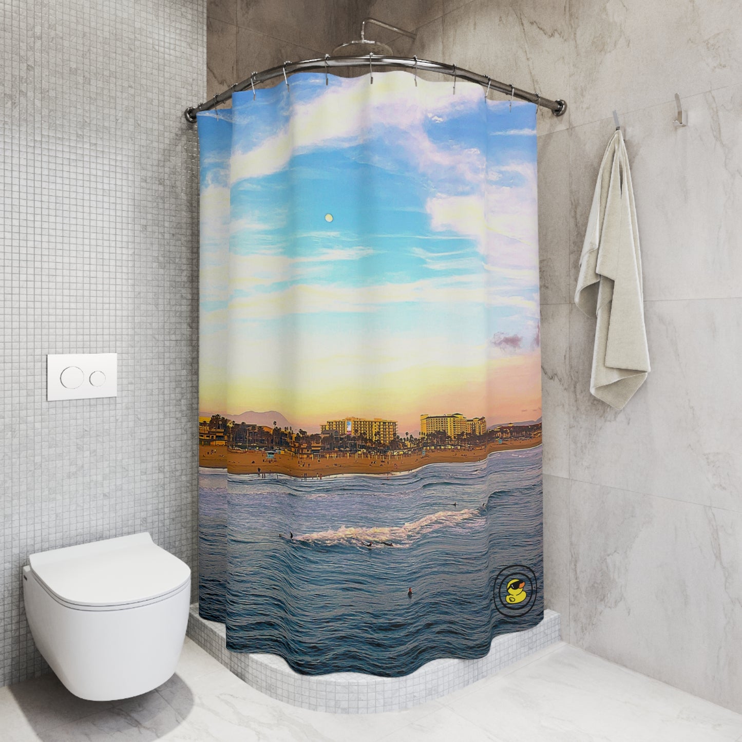 Beach sunset shower curtain with pastel sky, ocean waves, and coastal skyline in a modern renovated bathroom setting.
