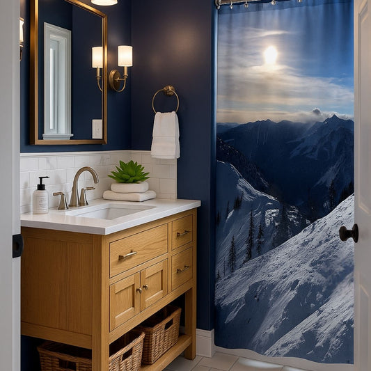 Bathroom with oak vanity and mountain-themed shower curtain, featuring navy blue walls, white tile, and natural accents for a calming spa-like design.