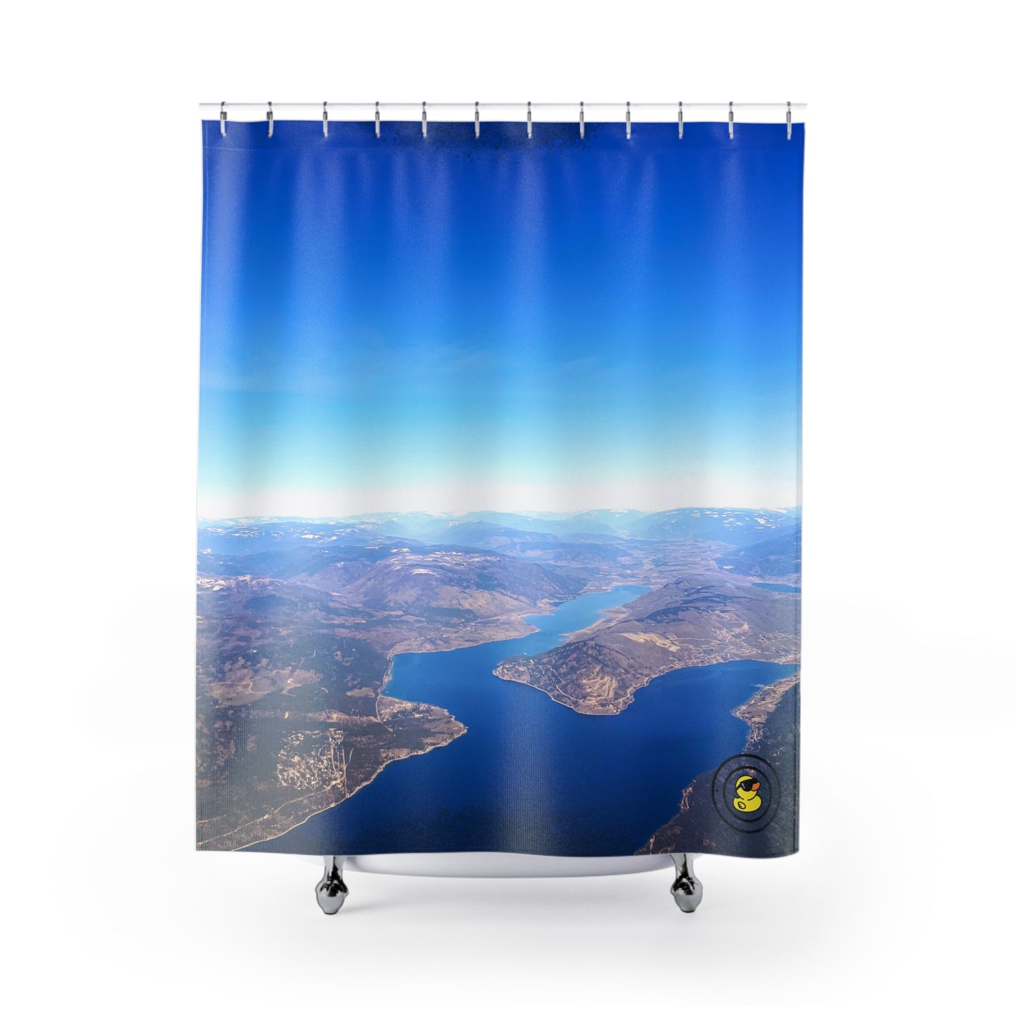 Aerial view of lakes and mountains printed on a shower curtain. Evoking a peaceful, sky-high escape.