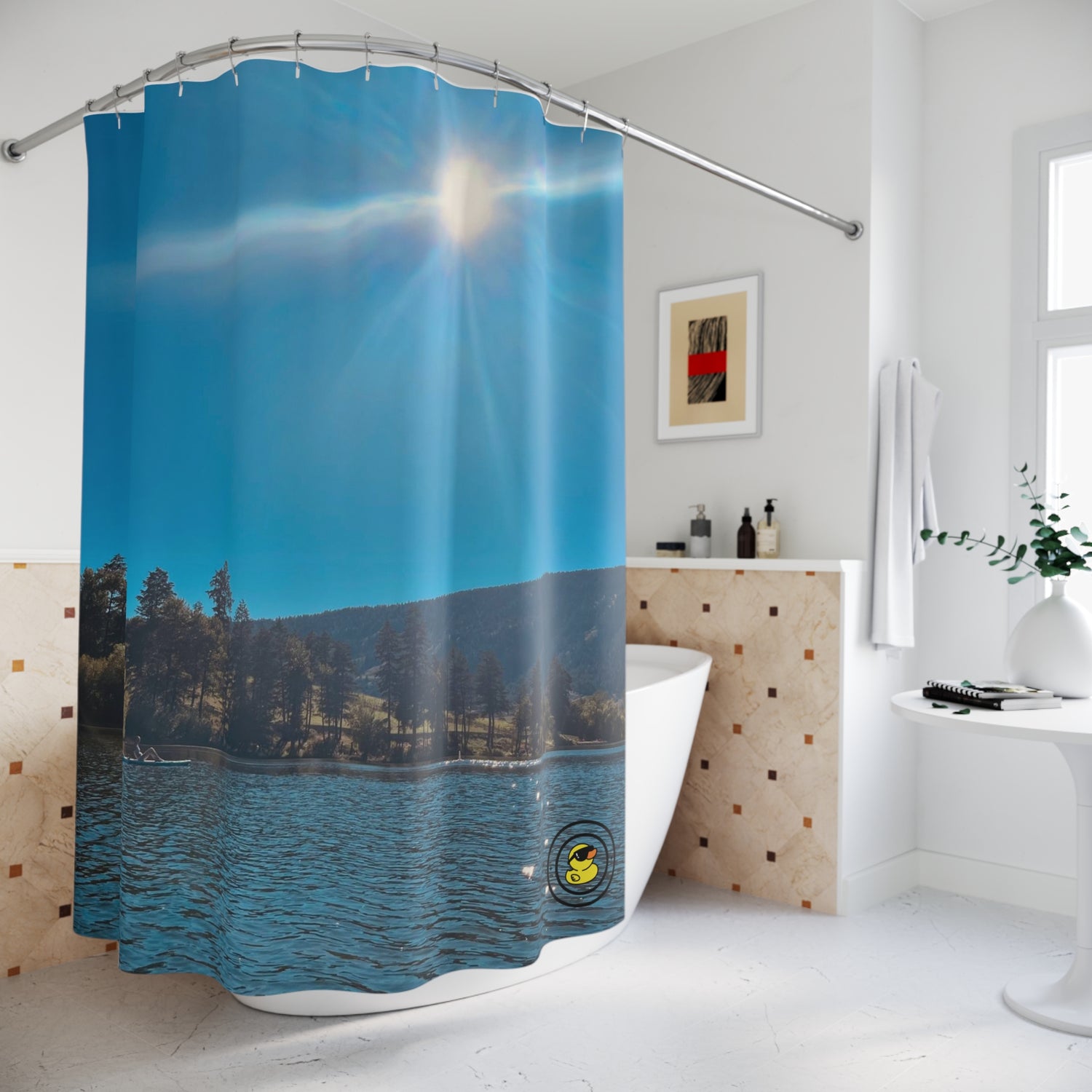 Shower curtain with a sunny lake view, calm water, forested hills, and a clear blue sky in a bright bathroom.