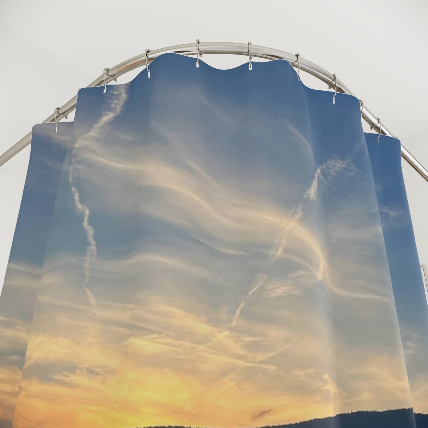 Shower curtain featuring wispy clouds drifting across a golden sunset sky. Creating a dreamy and tranquil effect.