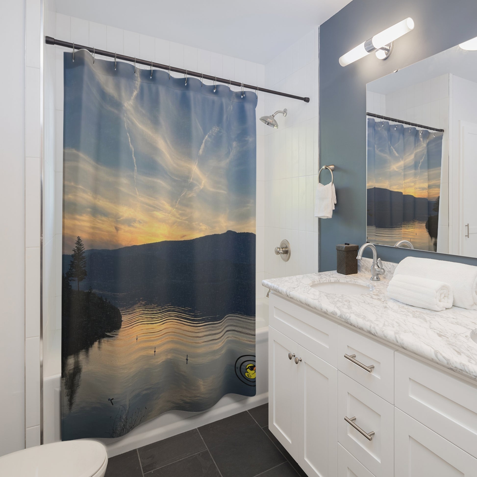 Bathroom with a lake sunset shower curtain, white vanity, marble countertop, and large wall mirror.