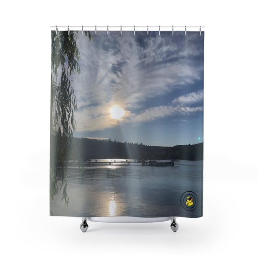 Lake sunset shower curtain with dock, calm water, and dramatic clouds under a glowing sun and willow branch.