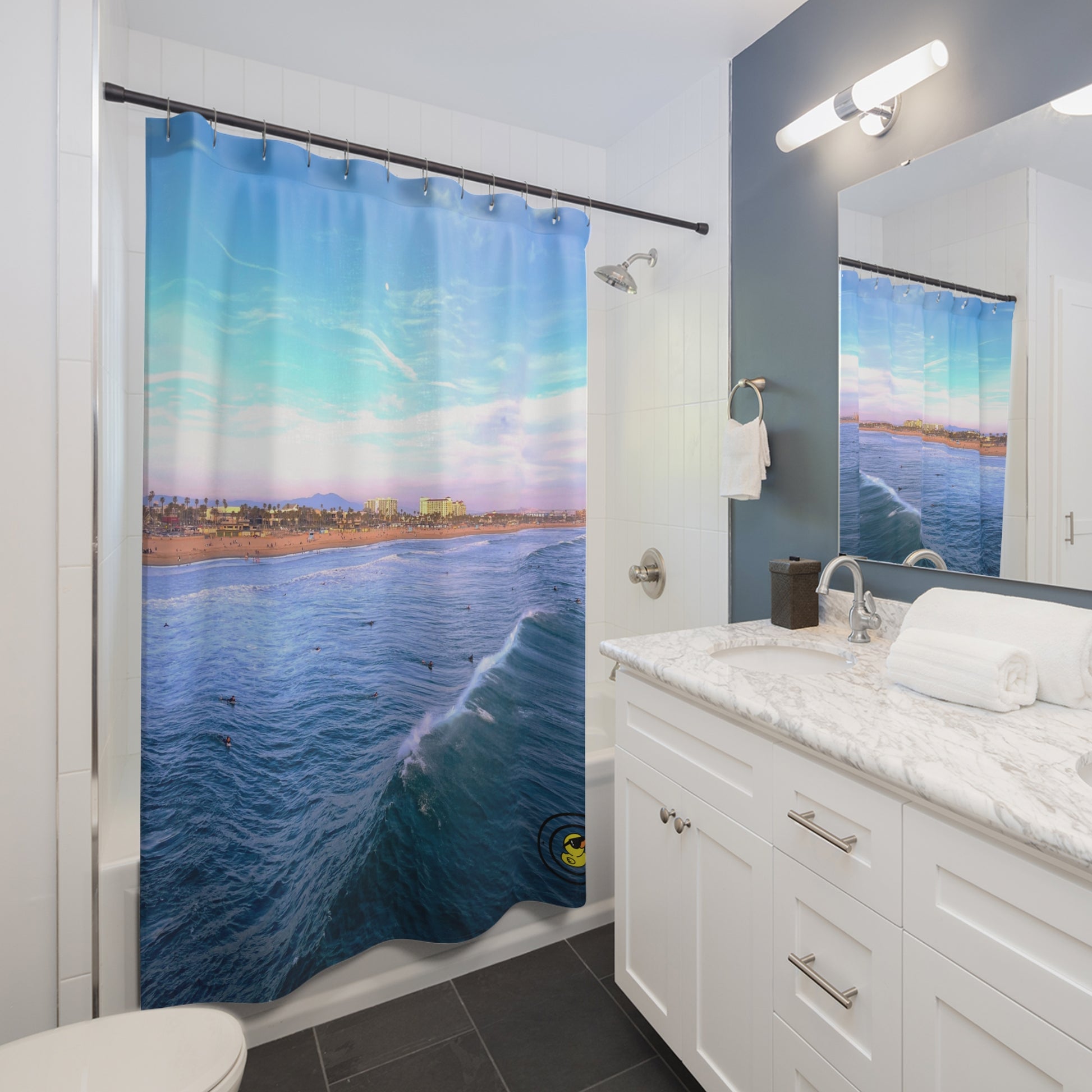 Ocean-themed shower curtain in modern bathroom. Featuring vibrant blue waves and beach view for a calming coastal vibe.