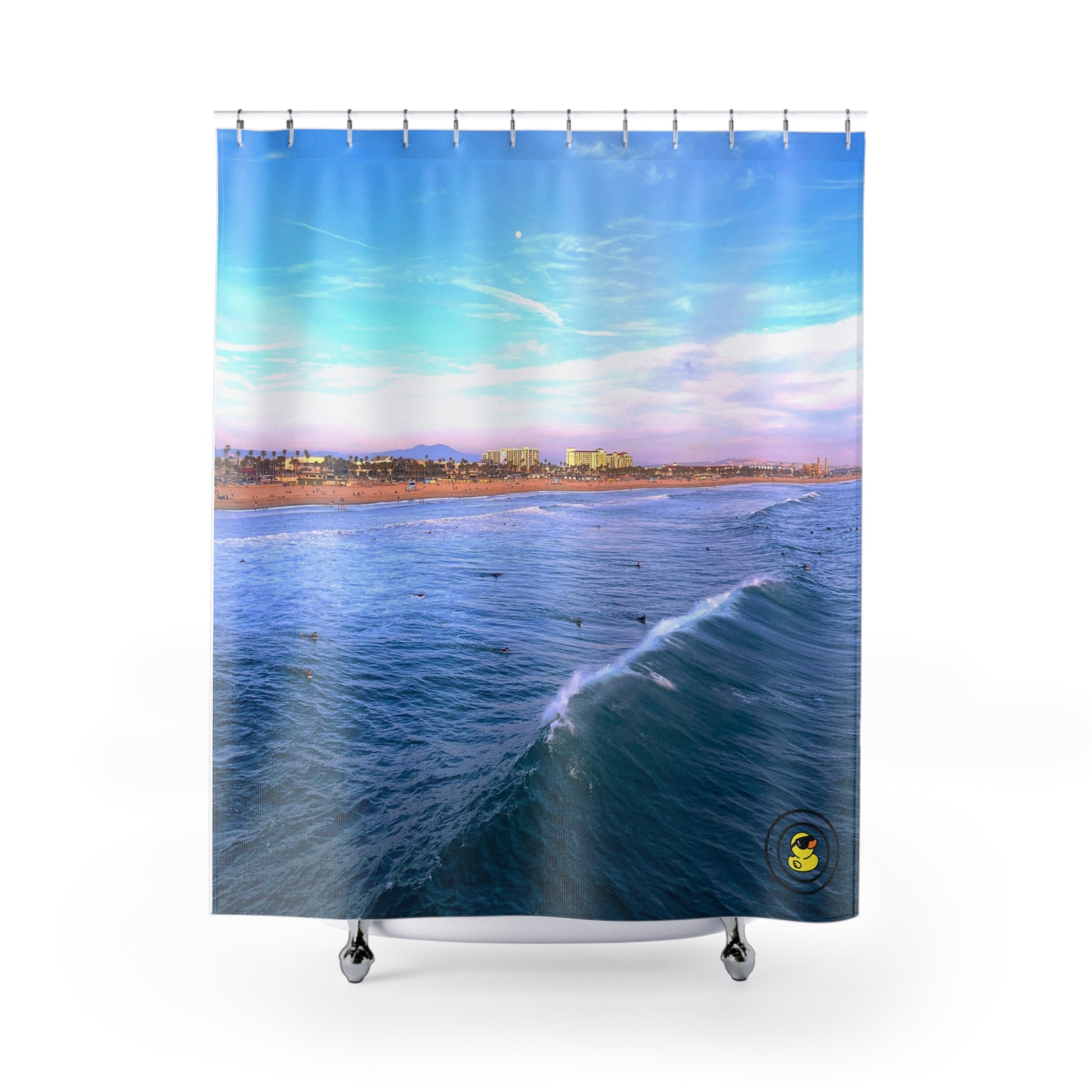 Vibrant shower curtain featuring surfers and ocean waves under a bright blue California sky near the coastline.