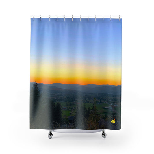 Scenic shower curtain with a glowing sunset over a valley and mountains. Adds warmth and calm to any bathroom.