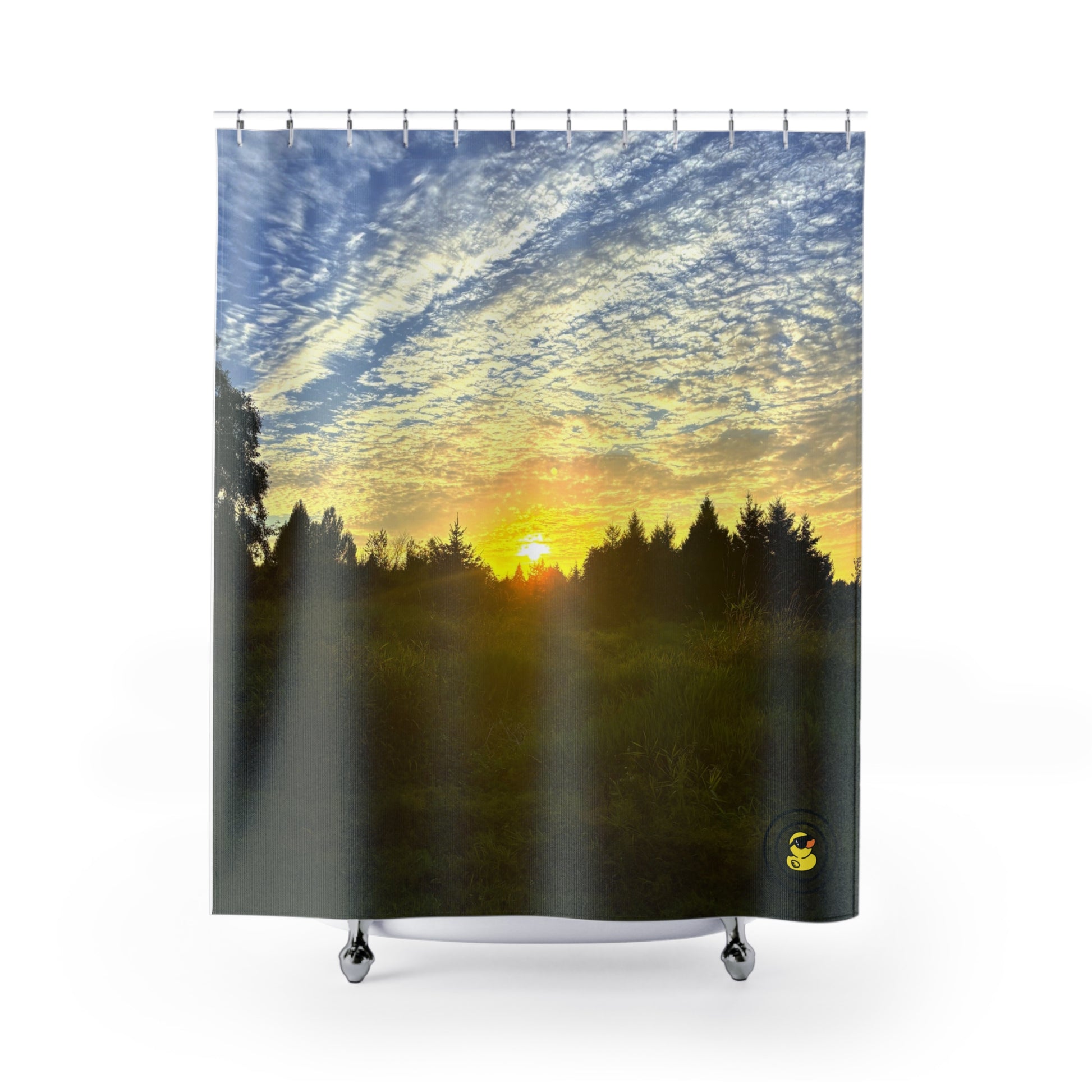 Sunset shower curtain with golden sky and forest silhouette. Adding warmth and nature to bathroom decor.